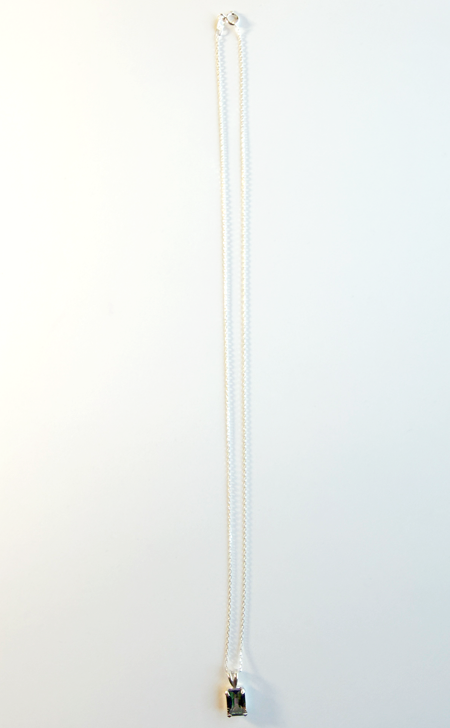 Sterling silver necklace with a mystic quartz pendant on a white background