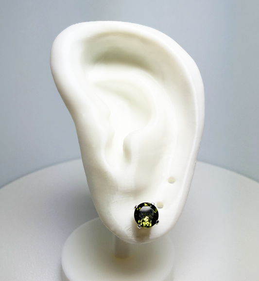 Green Moldavite gemstone stud earring on a white ear model with a gray background