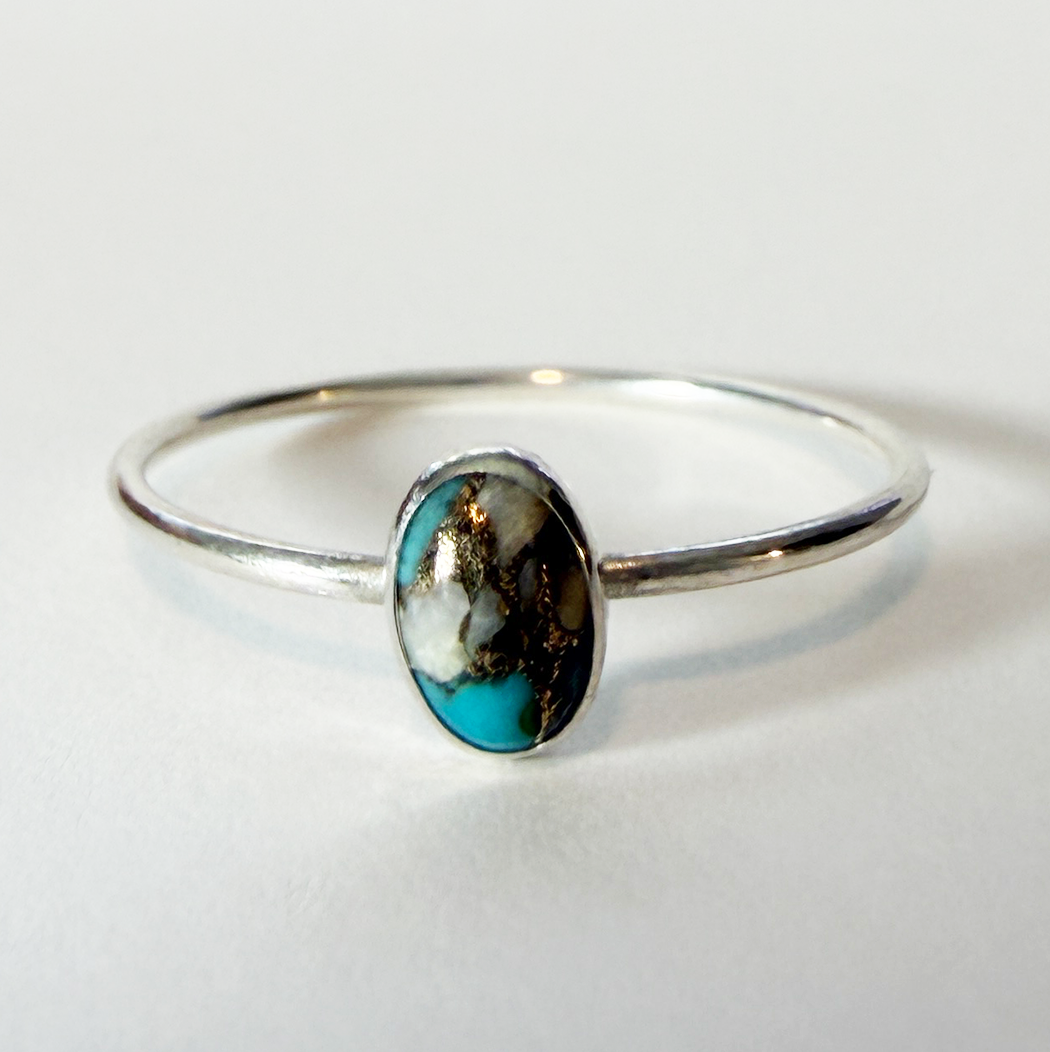 Sterling silver ring with a Spiny oyster copper turquoise stone on a white background