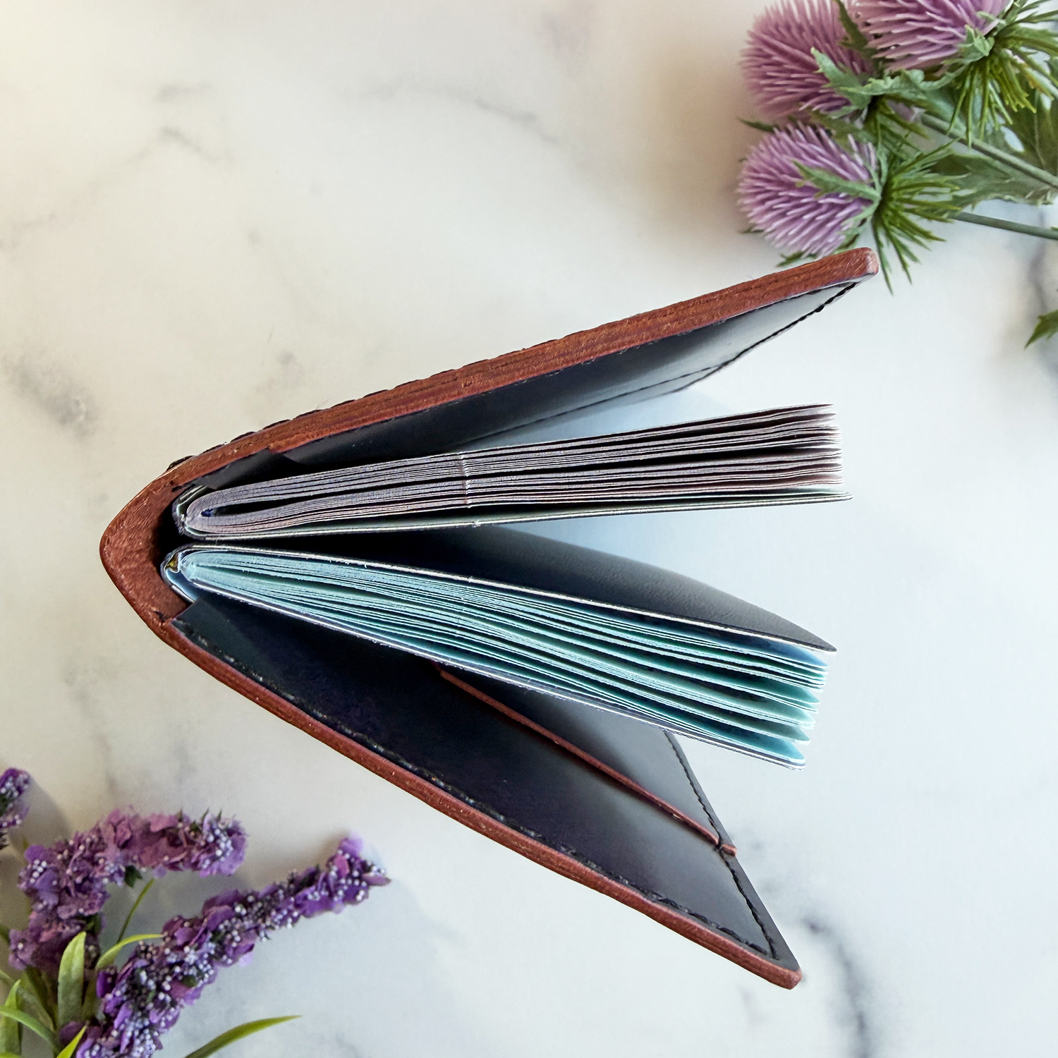A top view of a leather passport holder showing two passports inside.